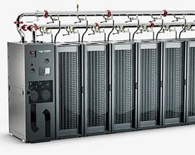 Row of liquid-cooled data center racks connected to overhead supply and return piping