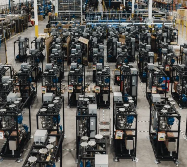 Aerial view of a large warehouse filled with rows of cooling racks and equipment.