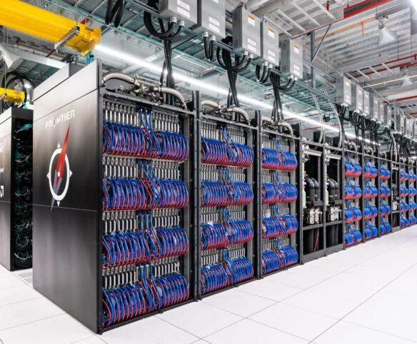 Exascale supercomputing racks with high-density servers and liquid cooling connections in a data centre environment.
